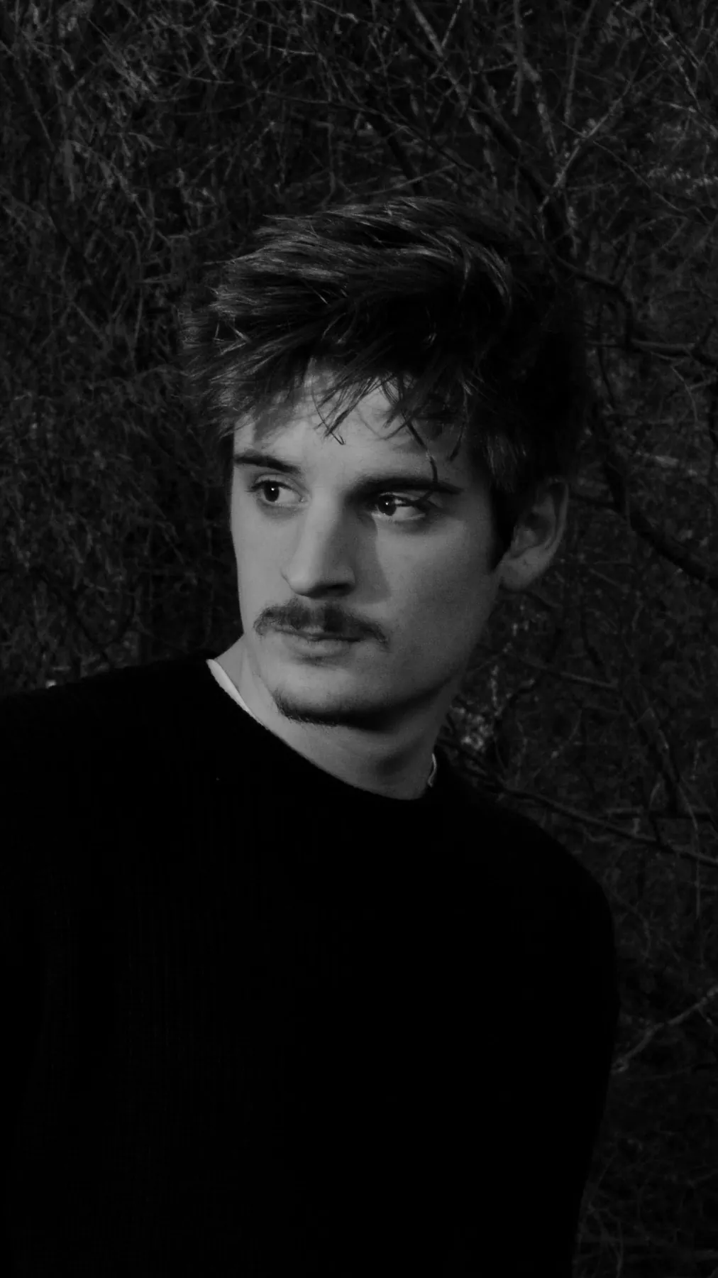 Close-up black-and-white portrait of Carlos Rodríguez.